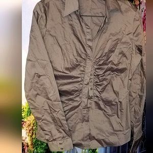 Grey button down shirt. Side hems give hour glass shape to the waist. (offers)